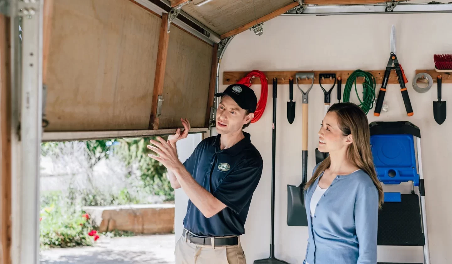 Precision Garage Door technician helping customer with garage door repairs Precision Garage Door technician helping customer with garage door repairs