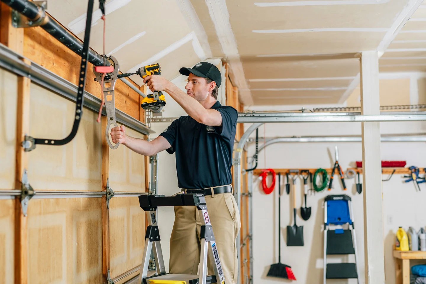 Precision Garage Door technician repairing a garage door center bearing Precision Garage Door technician repairing a garage door center bearing